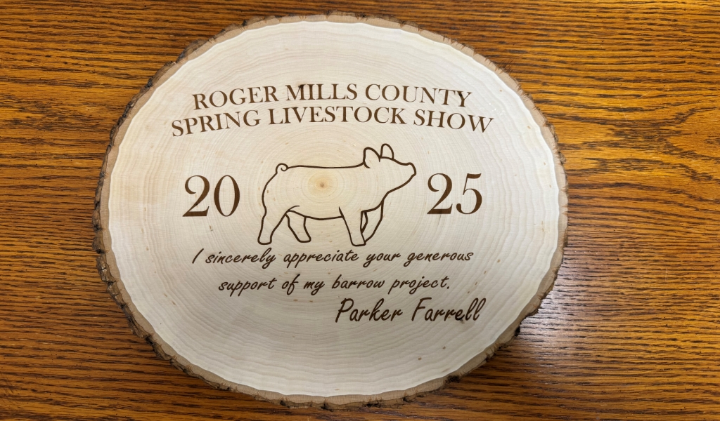 Wooden plaque for the Roger Mills County Spring Livestock Show 2025 features a carved pig illustration and a thank-you message for supporting Parker Farrell's barrow project.