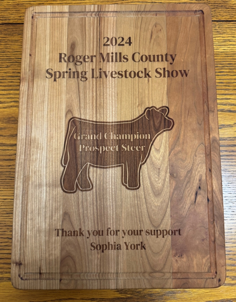 Wooden plaque for the 2024 Roger Mills County Spring Livestock Show, showcasing a carved steer.